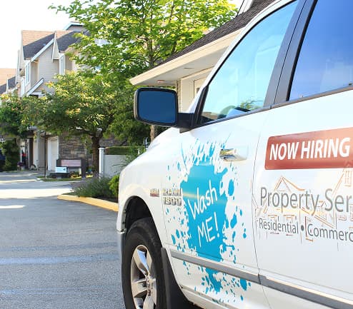 Washme team members cleaning a house exterior with professional equipment